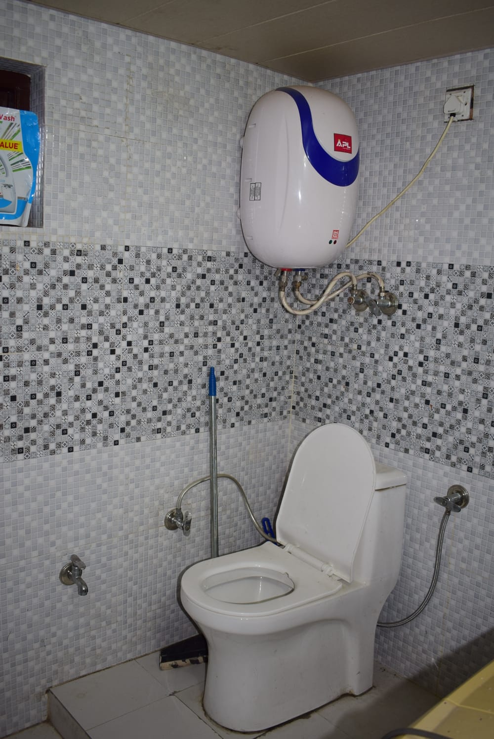 Clean bathroom with geyser and modern fittings