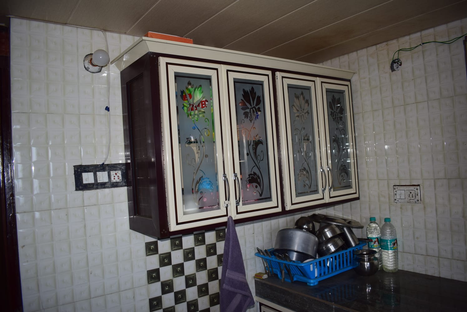 Kitchen with glass-door cabinets and storage