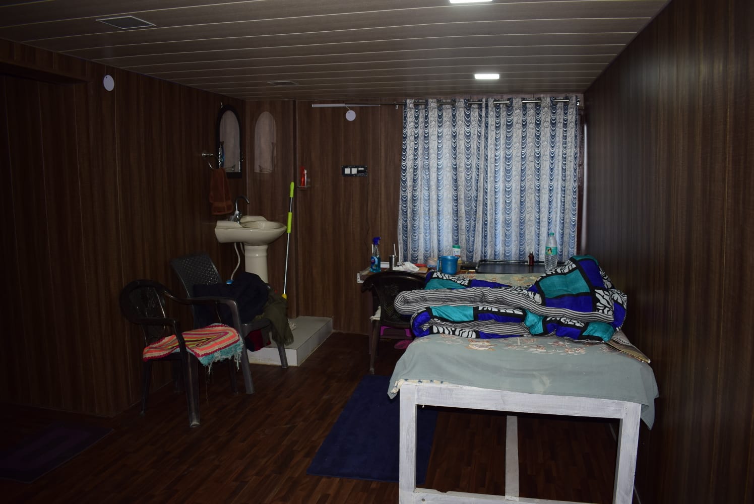 Room interior with wooden panelling and amenities